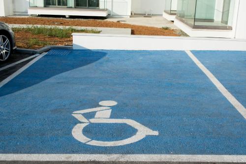 a handicapped parking lot with a toilet sign on it at Mandali Hotel in Protaras
