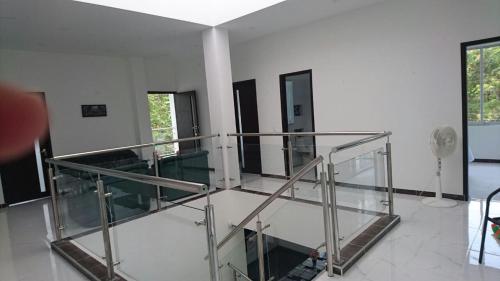 a lobby with a glass staircase in a building at Casa Quinta Santana in Melgar