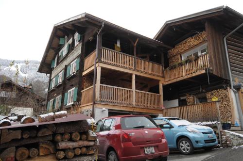 a house with cars parked in front of it at BnB Hasatrog Jenaz in Jenaz