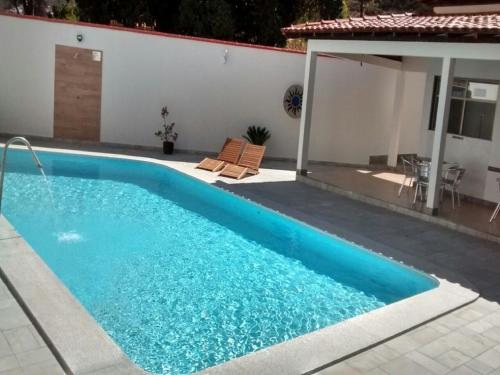 a swimming pool in the backyard of a house at Hotel Porto do Sol in Caetité