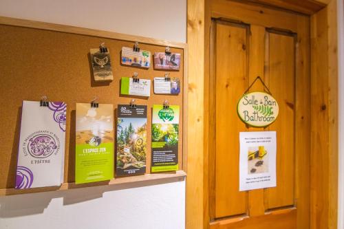 a bulletin board with posters on a wall at Centre de l'Hêtre in Lac-Beauport
