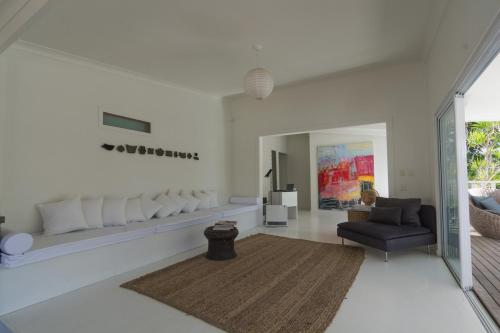 a living room with a couch and a chair at Byron Springs in Byron Bay