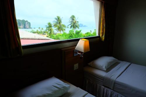 a window in a room with a bed and a window at Aonang Top View in Ao Nang Beach
