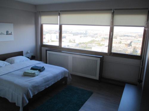 A bed or beds in a room at Genex Apartment