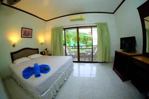 a bedroom with a bed with a blue bow on it at P.K. Mansion in Ao Nang Beach