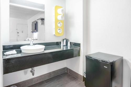 a bathroom with a sink and a mirror at Motel 6-Glassboro, NJ - Rowan University in Glassboro