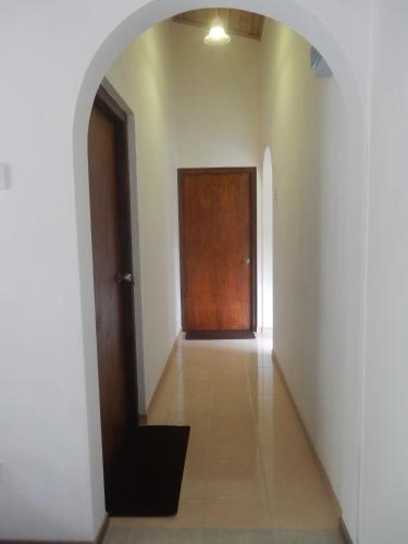 ein leerer Flur mit einer Tür und einem Fliesenboden in der Unterkunft Sisanda Residence in Bentota
