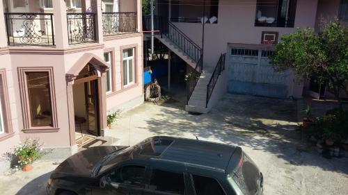 a black suv parked in front of a building at Guest House Roman/Gonio in Gonio