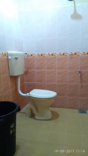 a bathroom with a toilet and a trash can at Relaxs Homestay in Kota Bharu
