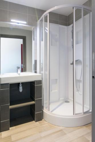 a bathroom with a shower and a sink at Village Le Grand Fourchon in Valmeinier