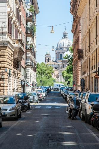 a city street with parked cars and buildings at Piazza Cavour Suite in Rome