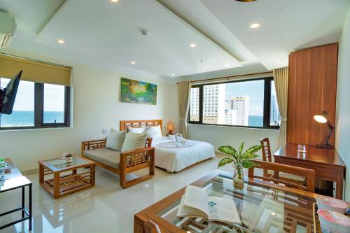 a living room with a bed and a table at Salamander Apartment hotel in Da Nang