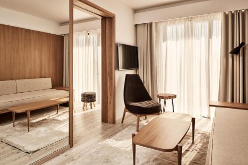 a living room with a couch and a mirror at Ibis Styles Heraklion Central in Heraklio Town