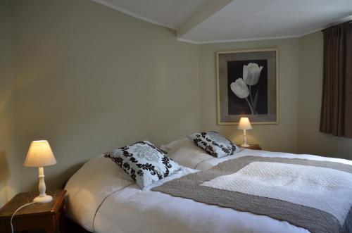 a bedroom with a bed with two pillows on it at Le Petit Maur in Spa