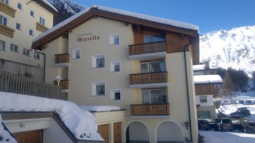 a building with a balcony with snow on it at Haus Musella in Samnaun