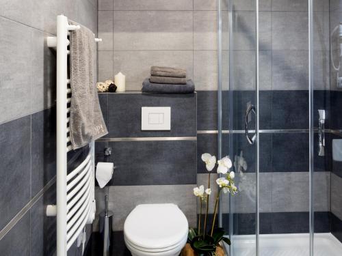 a bathroom with a toilet and a glass shower at Club Apartments in Čeladná