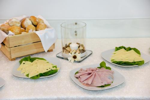 a table with plates of food and a box of donuts at Villa Crawford in Sant'Agnello