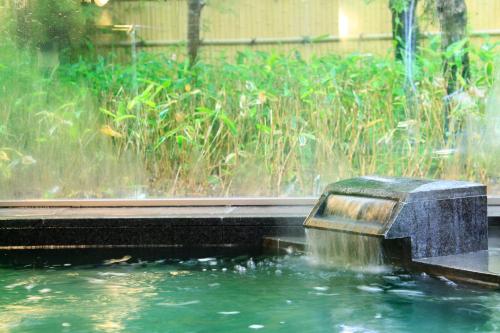 a water fountain in the middle of a pond at Hakone Fuga - Adult Only in Hakone