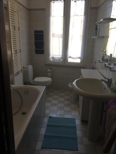 a bathroom with a tub and a toilet and a sink at Le Ruote in Vezzano sul Crostolo