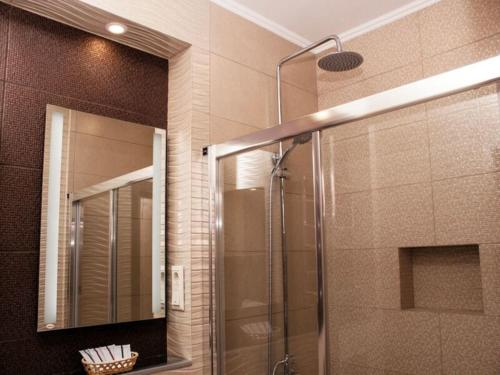 a bathroom with a shower and a mirror at Apartment in the city center in the house with Atlantes in Odesa