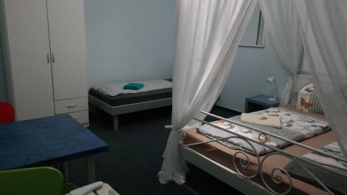 a small room with two beds and a table and a desk at Hostel Inn-Berlin in Berlin