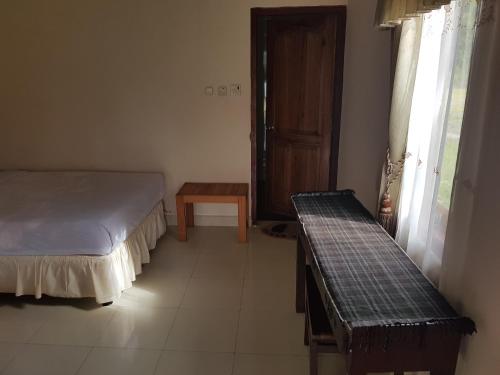 Кровать или кровати в номере Rinjani Family Homestay