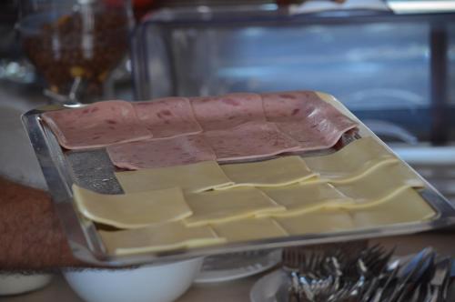 a tray of food with a tray of cheese at Dimitropoulos Apartments in Eleonas