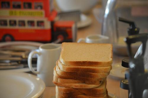 a stack of bread on a counter next to a cup at Dimitropoulos Apartments in Eleonas