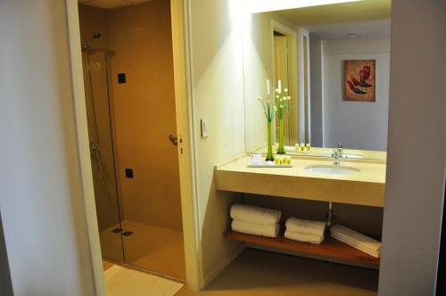 a bathroom with a sink and a mirror at Uno Buenos Aires Suites in Buenos Aires