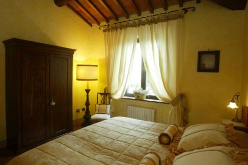 Ένα ή περισσότερα κρεβάτια σε δωμάτιο στο Agriturismo Borgo La Casetta