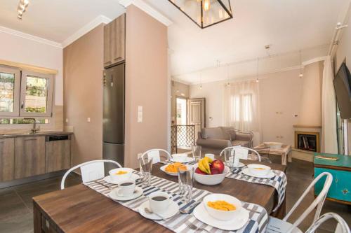 a kitchen and dining room with a table and chairs at Karya Villas in Kariá