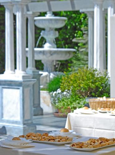 a table with plates of food on top at Hotel Europa in Lido di Camaiore