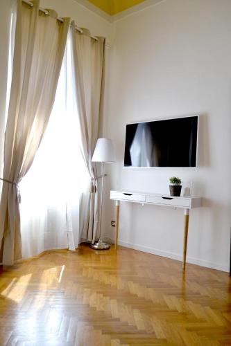 a living room with a flat screen tv and a window at Domus Duomo in Florence