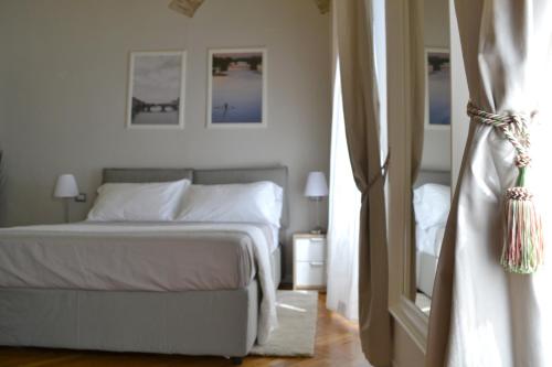 a bedroom with a white bed and a window at Domus Duomo in Florence