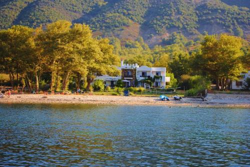 a house on the shore of a body of water at Archondissa Beach Aparthotel in Therma