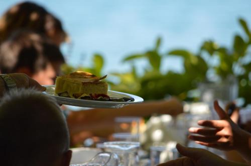 a person holding a plate with a piece of cake at Dimitropoulos Apartments in Eleonas