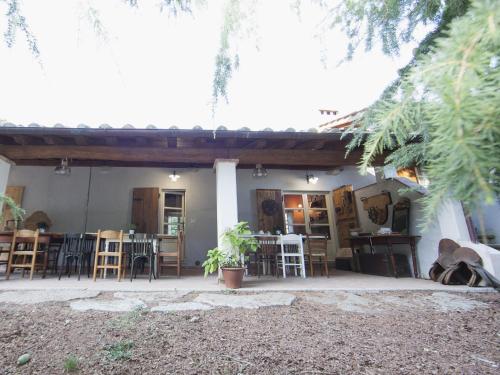 a house with a patio with chairs and tables at Fonte di Zeno in Marciana