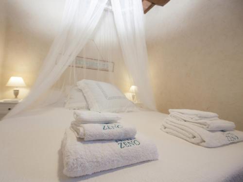 a white bed with towels on top of it at Fonte di Zeno in Marciana