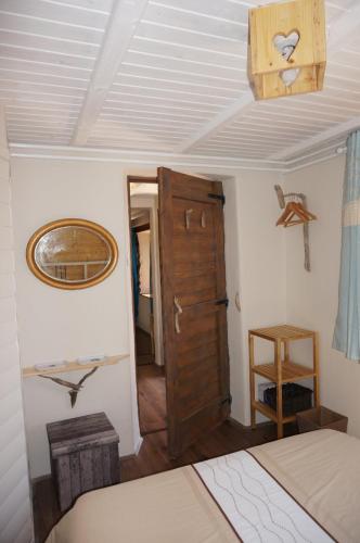 a bedroom with a bed and a wooden door at Valley View Apartment in Kambreško