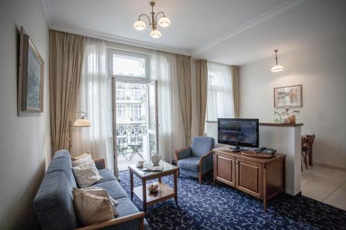 a living room with a couch and a tv at Apartamenty Villa Artis in Świnoujście