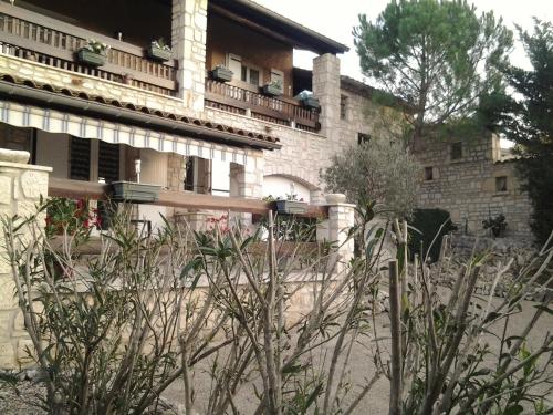 a building with a fence in front of it at Les Lauriers Roses in Salavas