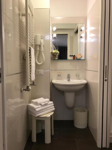 a white bathroom with a sink and a mirror at Hotel Mezzo Pozzo in Venice