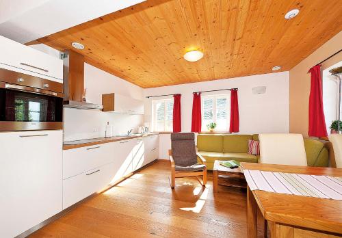 a kitchen and living room with a couch and a table at Ferienhaus Winterbergblick in Hinterhermsdorf