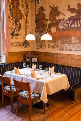 a table in a restaurant with a white table cloth at Hotel Eisbach in Ransbach-Baumbach