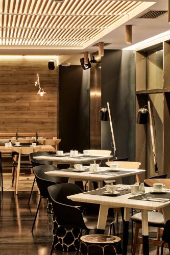 a row of tables and chairs in a restaurant at Ibis Styles Heraklion Central in Heraklio Town