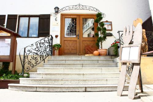 a front door of a house with a pumpkin on the stairs at Bimesmeier Gasthof & Pension in Kößlarn