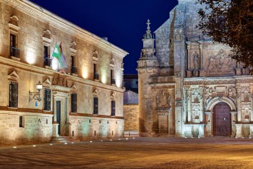 a building with a flag in front of it at Parador de Ubeda in Úbeda