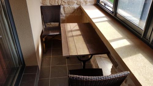 a table and chair in a room with a window at Auberge de Marville in Marville