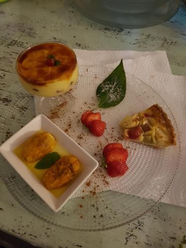 a plate of food with a donut and strawberries on it at Acquasale in Castrovillari