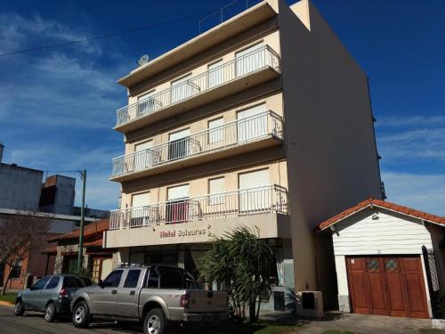 a building with a truck parked in front of it at Hotel Soleares in Mar del Plata